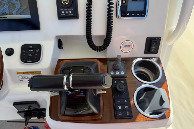 Slide: The Image of Control panel of a 2018 Hunt 32cc boat with throttle and navigation controls. - 12