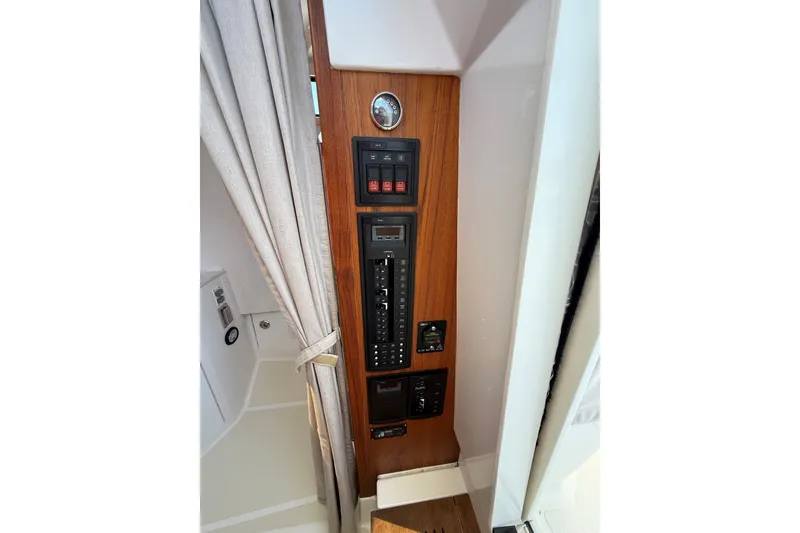 Slide: The Image of Control panel on a 2018 Hunt 32cc boat, featuring switches and gauges. - 41