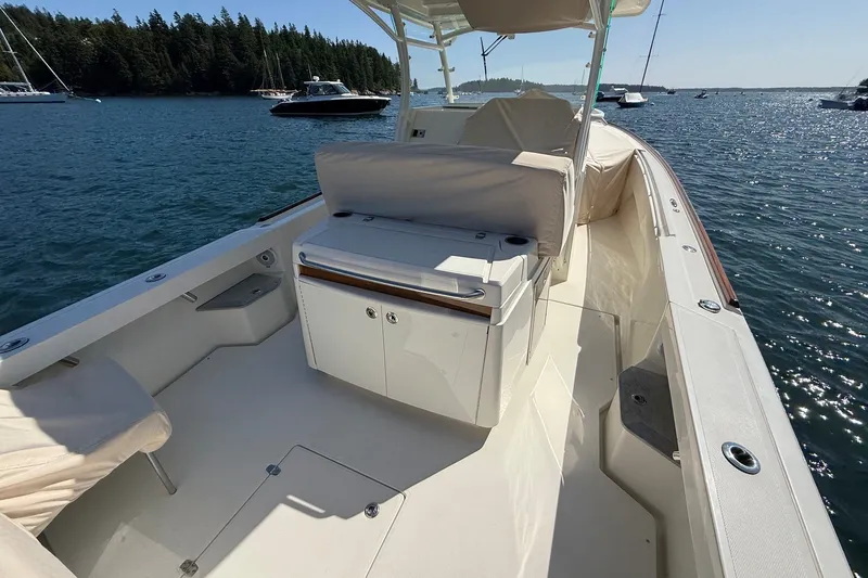 Slide: The Image of 2018 Hunt 32cc boat on water, featuring spacious deck and seating area. - 20