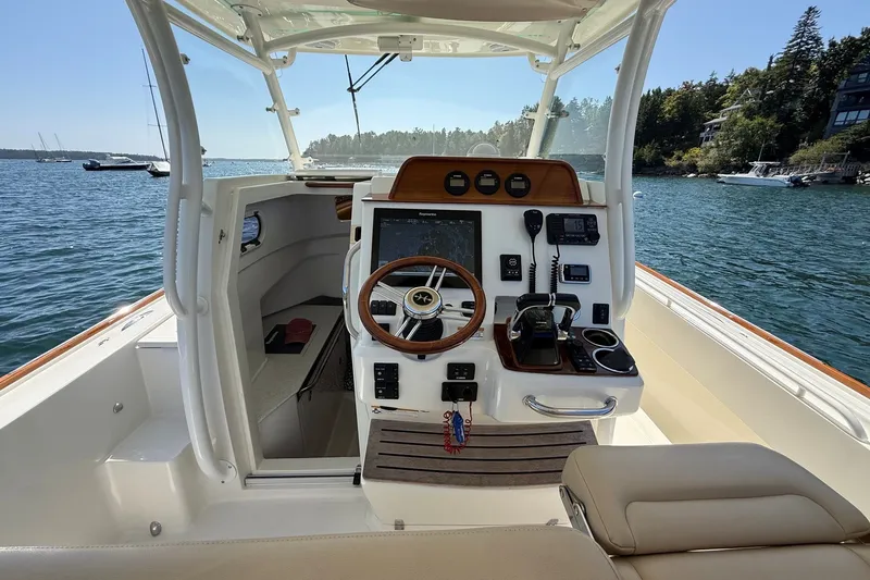 Slide: The Image of Helm of 2018 Hunt 32cc boat with steering wheel, controls, and navigation equipment. - 8