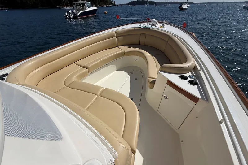 Slide: The Image of Luxurious 2018 Hunt 32cc boat interior with tan seating, on a serene water backdrop. - 27