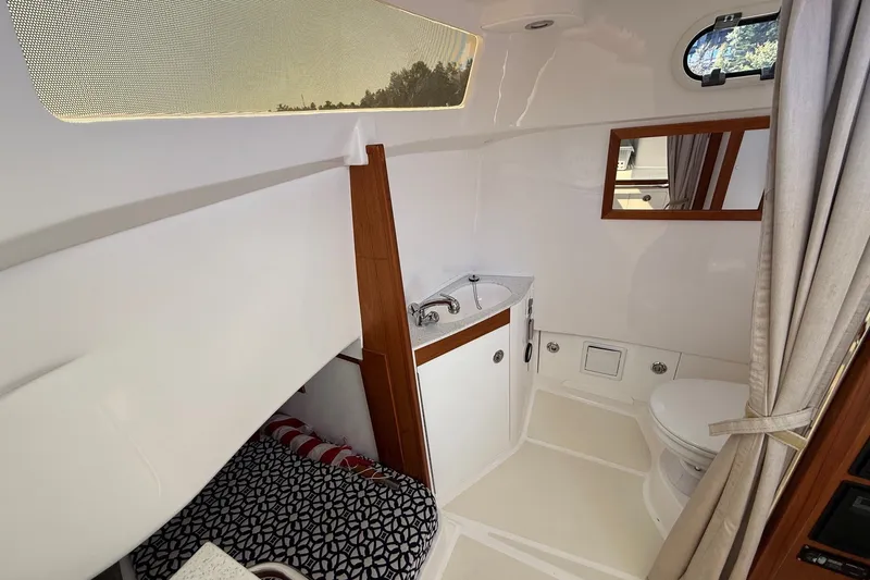 Slide: The Image of Compact boat interior with sink, toilet, and bed in a 2018 Hunt 32cc model. - 39