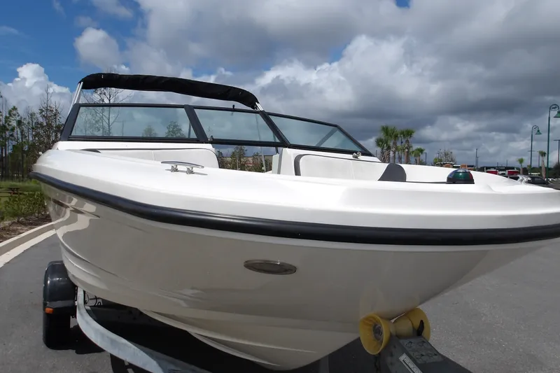 The Image of 2023 Stingray 173 CC boat on trailer under cloudy sky. - 0