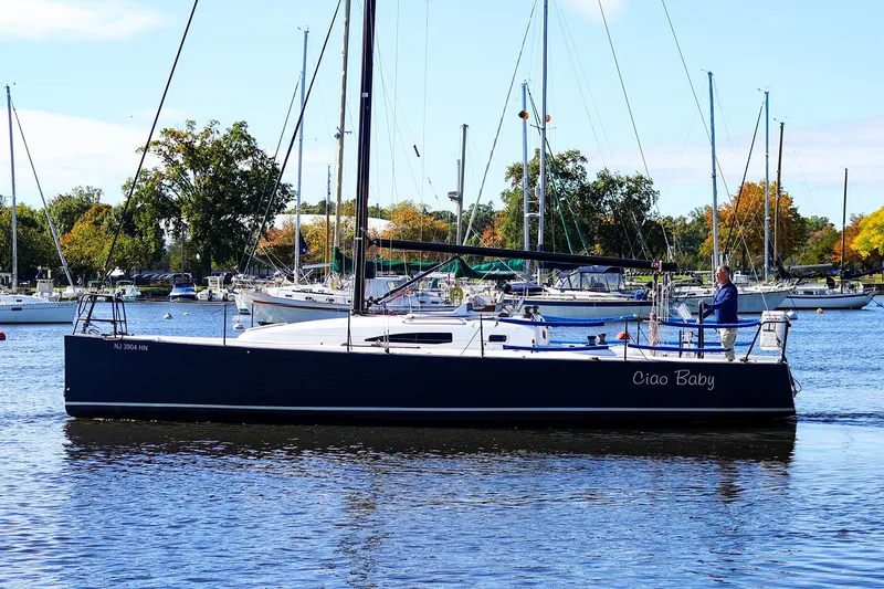 The Image of 2014 J Boats J/111 sailboat named "Ciao Baby" on a calm marina. - 1