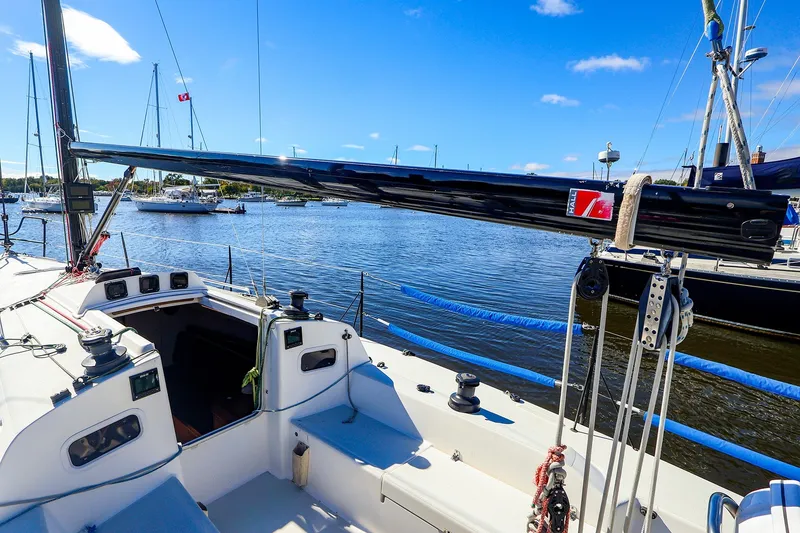 Slide: The Image of 2014 J Boats J/111 sailboat deck with rigging, docked in a marina under clear skies. - 22