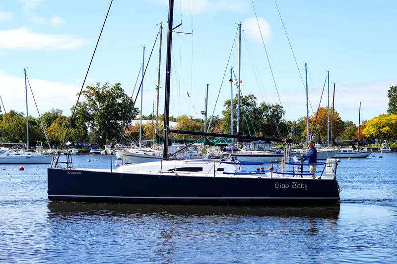 Slide: The Image of 2014 J Boats J/111 sailboat "Ciao Baby" on a calm lake with trees in the background. - 27