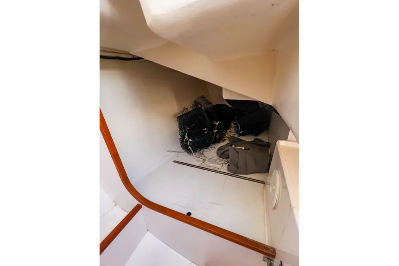 Slide: The Image of Interior of 2014 J Boats J/111 sailboat, showing storage area with bags and equipment. - 32