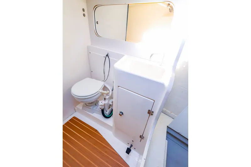 Slide: The Image of 2014 J Boats J/111 yacht bathroom with toilet, sink, and wooden flooring. - 38