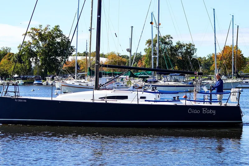 Slide: The Image of 2014 J Boats J/111 sailboat "Ciao Baby" docked in a marina with trees in background. - 26