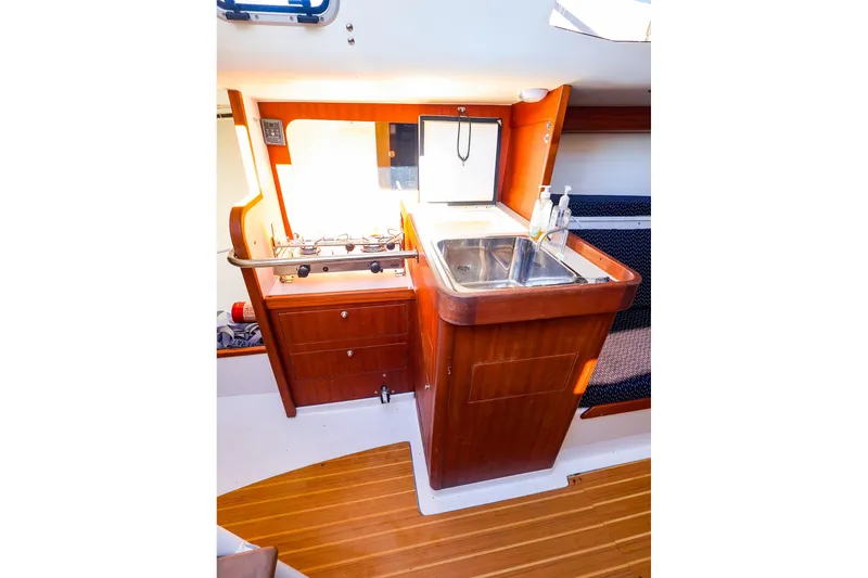 Slide: The Image of 2014 J Boats J/111 interior galley with stove, sink, and wooden cabinetry. - 30