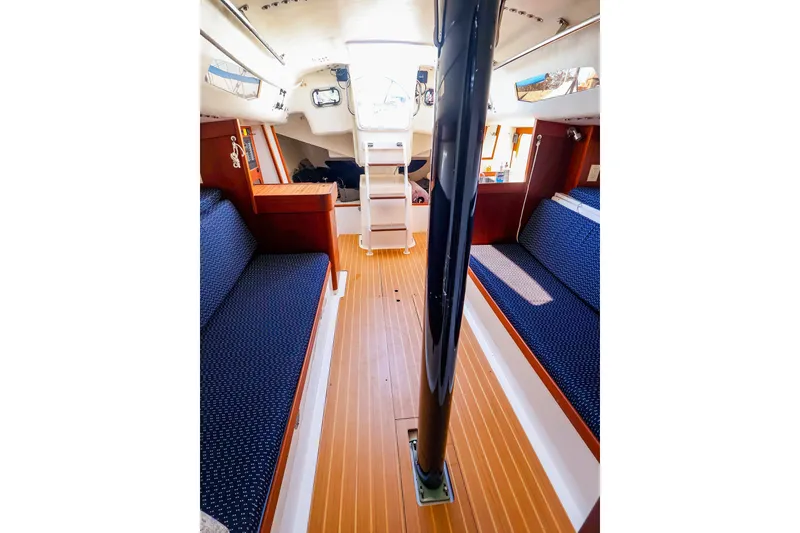 Slide: The Image of Interior of 2014 J Boats J/111 sailboat with wooden flooring and blue seating. - 37