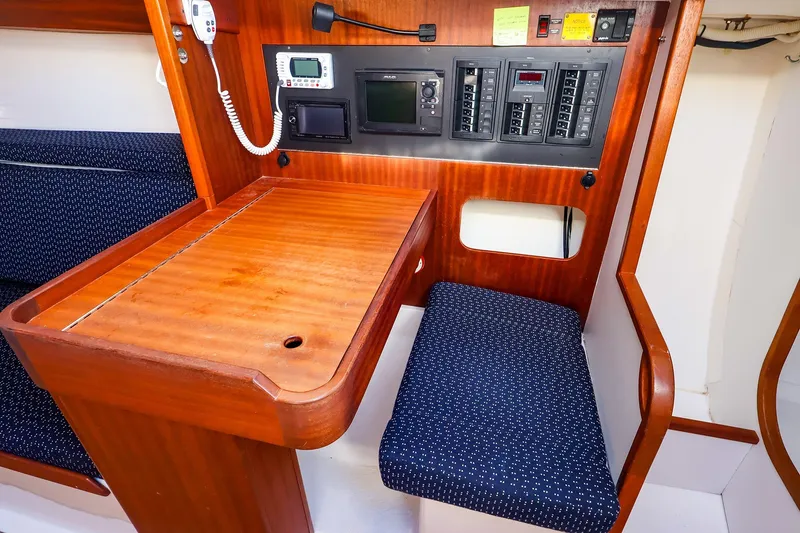 Slide: The Image of Navigation station inside 2014 J Boats J/111 sailboat, featuring control panels and seating. - 33