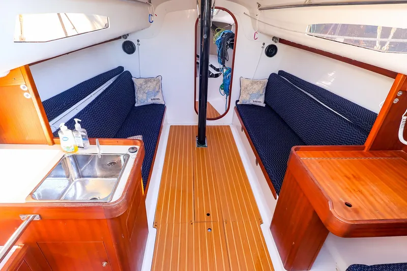 Slide: The Image of Interior of 2014 J Boats J/111 sailboat with wooden flooring and cozy seating. - 29