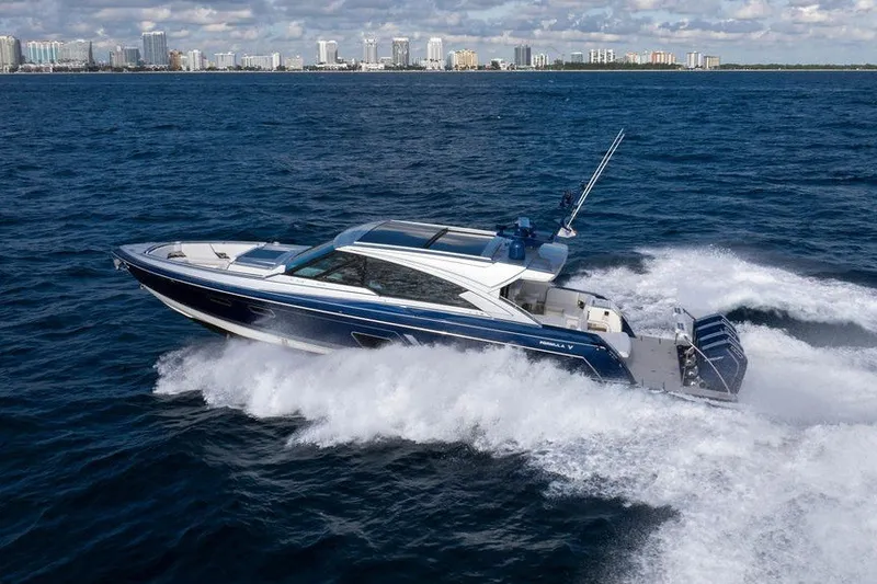 Slide: The Image of 2025 Formula 500 Super Sport Crossover yacht cruising on open water, city skyline in background. - 23