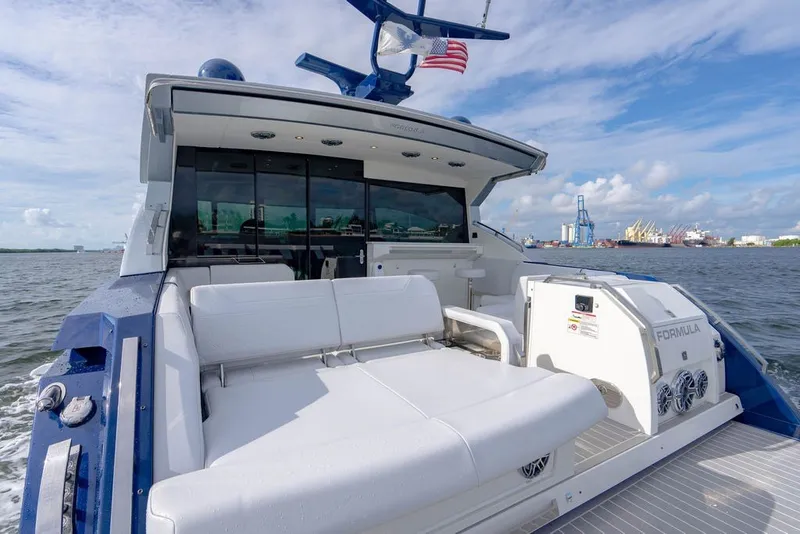 Slide: The Image of 2025 Formula 500 Super Sport Crossover yacht on water, featuring luxurious seating and sleek design. - 59