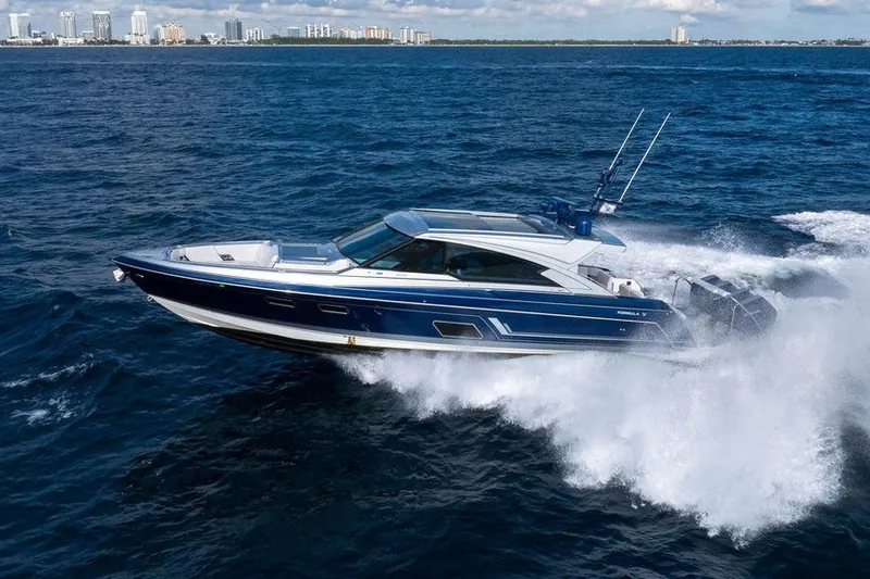 Slide: The Image of 2025 Formula 500 Super Sport Crossover cruising on ocean waves near city skyline. - 22