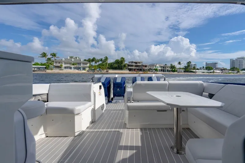Slide: The Image of 2025 Formula 500 Super Sport Crossover boat interior with luxurious seating and table, ocean view. - 54