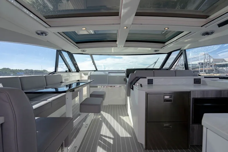 Slide: The Image of Interior of 2025 Formula 500 Super Sport Crossover yacht with modern seating and panoramic windows. - 96