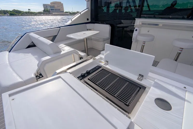 Slide: The Image of Luxurious 2025 Formula 500 Super Sport Crossover yacht with sleek seating and grill area. - 63