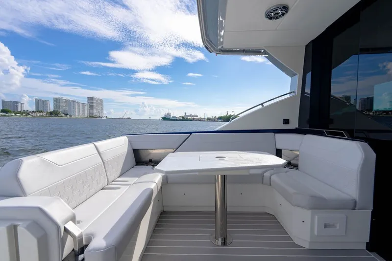 Slide: The Image of Luxurious seating area on 2025 Formula 500 Super Sport Crossover yacht, overlooking waterfront cityscape. - 60