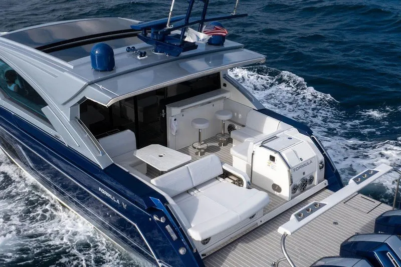 Slide: The Image of 2025 Formula 500 Super Sport Crossover yacht cruising on open water, featuring luxurious seating and sleek design. - 33