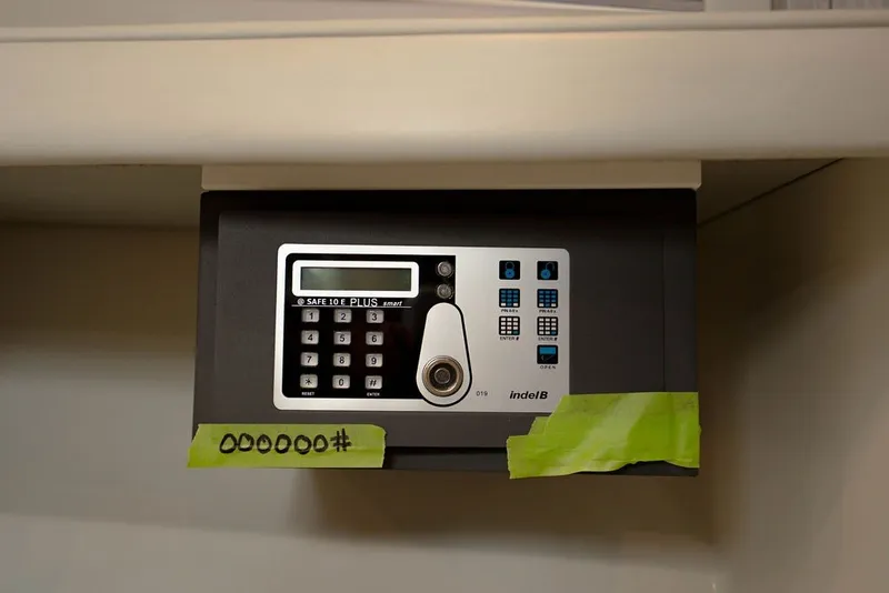 Slide: The Image of A digital safe with keypad and taped code, featuring a modern design. - 117
