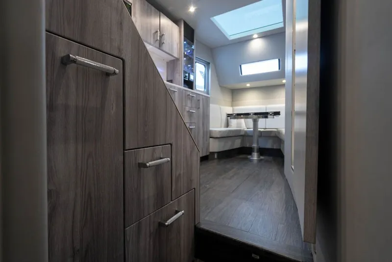 Slide: The Image of Interior of 2025 Formula 500 Super Sport Crossover, featuring modern wood cabinetry and seating area. - 48