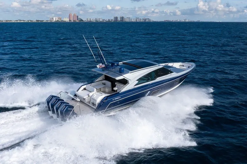 Slide: The Image of 2025 Formula 500 Super Sport Crossover cruising on ocean with city skyline in background. - 13