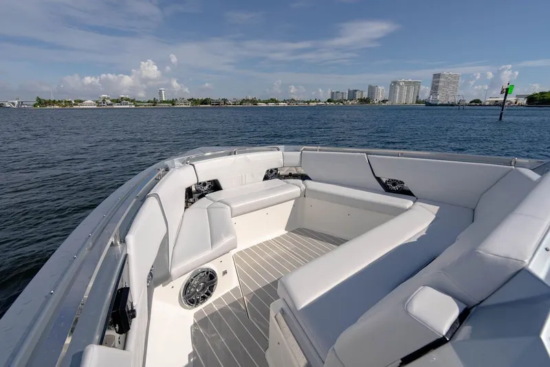 Slide: The Image of Luxury seating on 2025 Formula 500 Super Sport Crossover boat, with waterfront cityscape view. - 113
