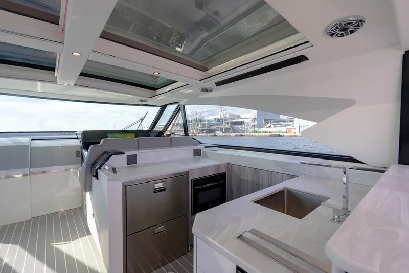 Slide: The Image of Luxurious interior of 2025 Formula 500 Super Sport Crossover yacht with modern kitchen amenities. - 78