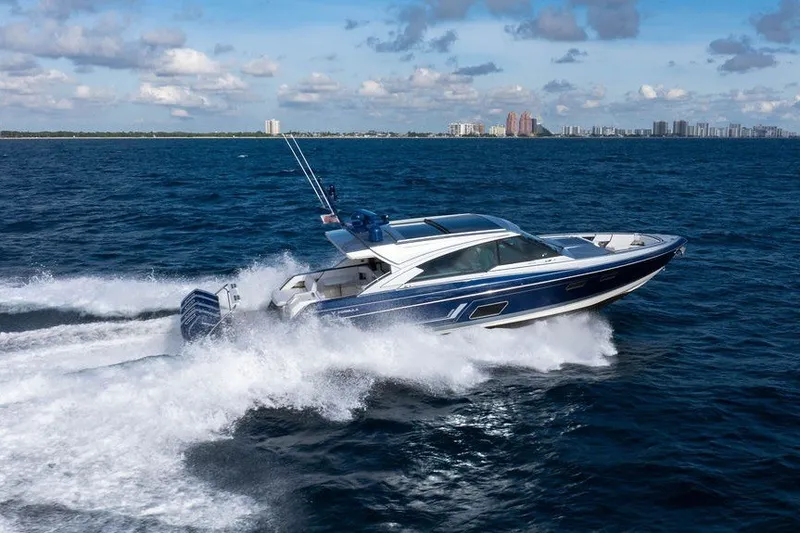 Slide: The Image of 2025 Formula 500 Super Sport Crossover cruising on open water, city skyline in background. - 14