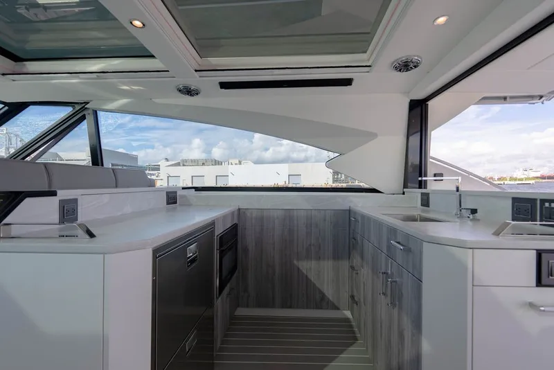 Slide: The Image of Luxurious interior of 2025 Formula 500 Super Sport Crossover yacht with modern kitchen amenities. - 100