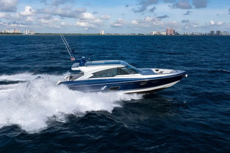 Slide: The Image of 2025 Formula 500 Super Sport Crossover cruising on open ocean under blue sky. - 16