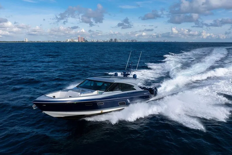 Slide: The Image of 2025 Formula 500 Super Sport Crossover yacht cruising on open ocean under blue sky. - 25