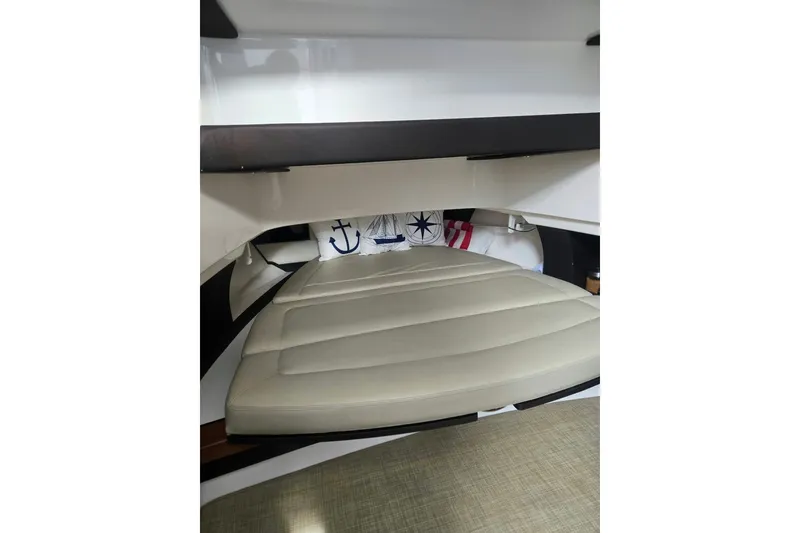 Slide: The Image of Interior cabin of 2018 Pursuit S 368 Sport boat with cushioned seating and nautical decor. - 32