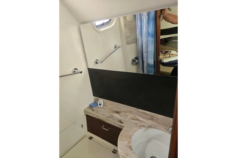 Slide: The Image of 2018 Pursuit S 368 Sport boat bathroom with sink, mirror, and storage cabinet. - 15
