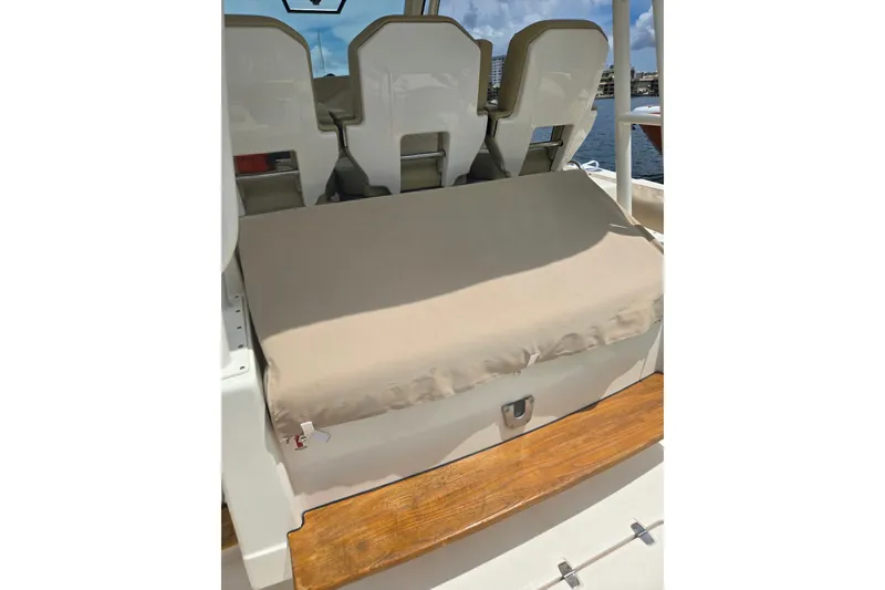 Slide: The Image of 2018 Pursuit S 368 Sport boat seating with beige cover and wooden step. - 29