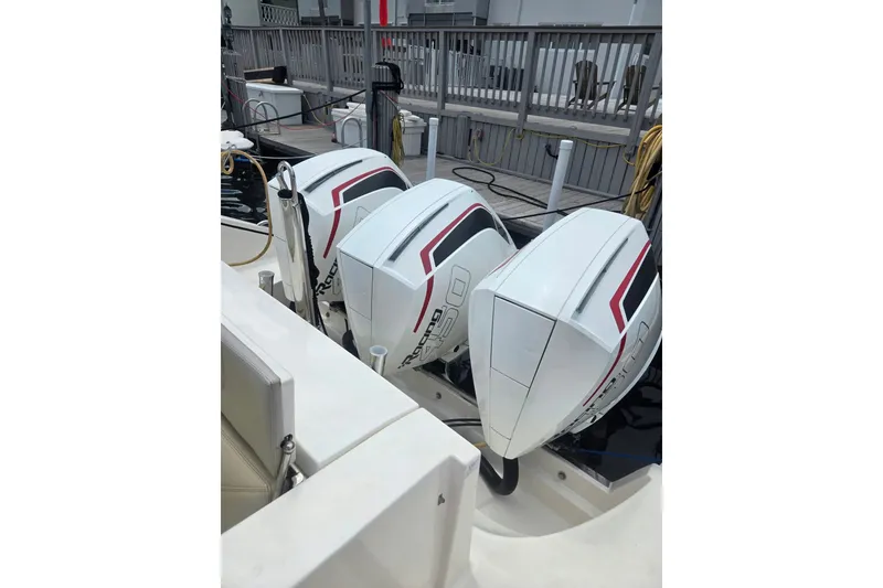 Slide: The Image of 2018 Pursuit S 368 Sport boat with triple outboard engines docked. - 20