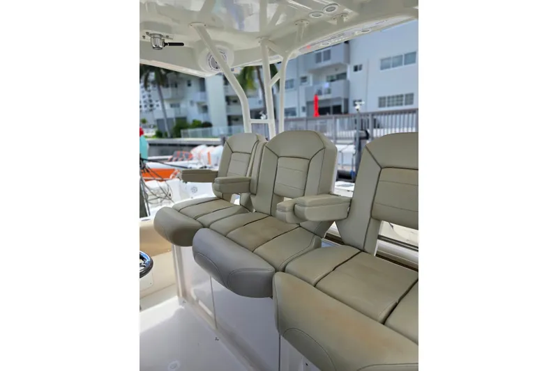 Slide: The Image of 2018 Pursuit S 368 Sport boat interior with luxurious seating and armrests. - 23