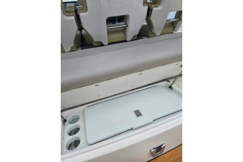 Slide: The Image of 2018 Pursuit S 368 Sport boat interior with storage compartment and cup holders. - 22