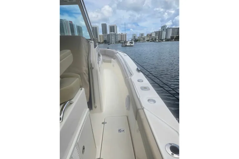 Slide: The Image of 2018 Pursuit S 368 Sport boat on water with city skyline in background. - 26