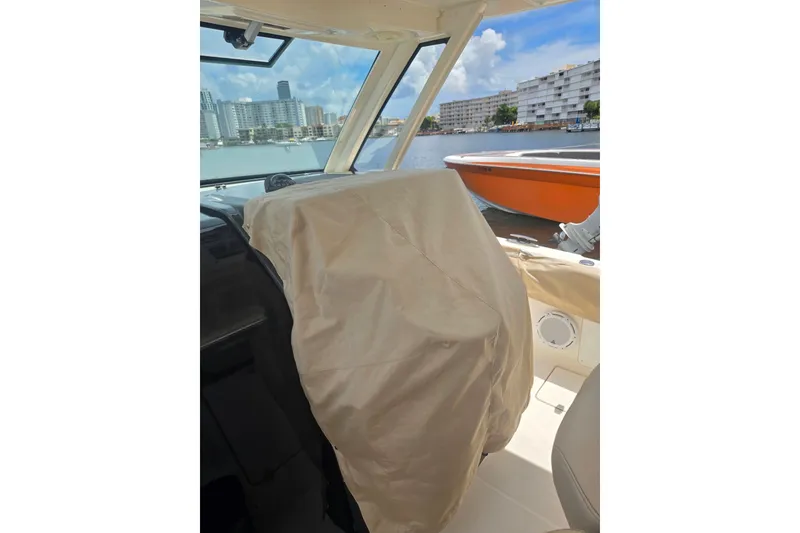 Slide: The Image of Interior view of 2018 Pursuit S 368 Sport boat with covered helm. - 30