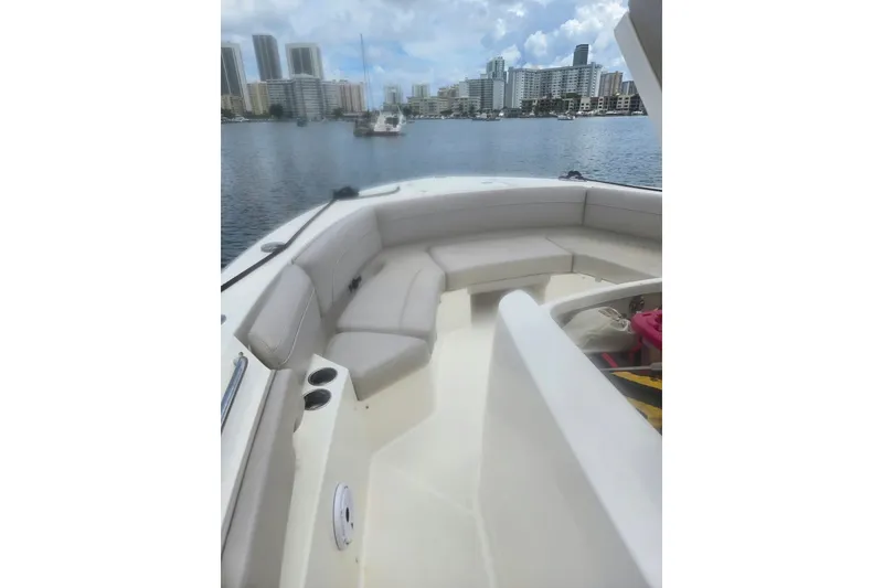Slide: The Image of 2018 Pursuit S 368 Sport boat interior with waterfront city skyline view. - 13