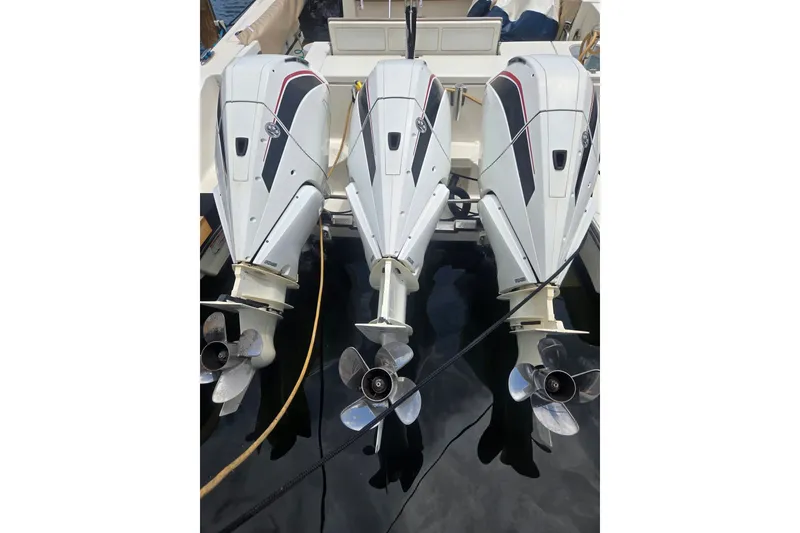Slide: The Image of Triple outboard engines on a 2018 Pursuit S 368 Sport boat. - 19