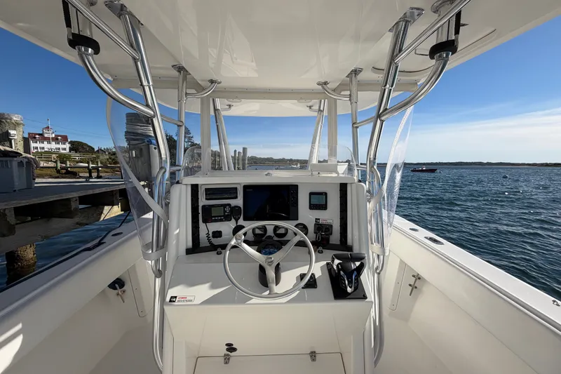 Slide: The Image of 2003 Venture 34 Open boat cockpit with steering wheel and navigation equipment. - 11