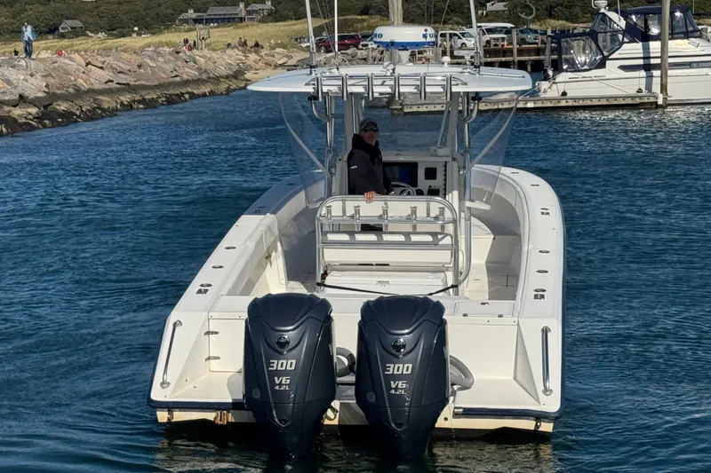 Slide: The Image of 2003 Venture 34 Open boat with dual 300 V6 engines on water. - 6