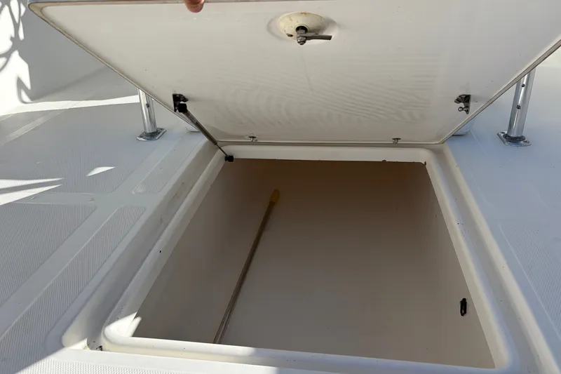 Slide: The Image of Open storage compartment on a 2003 Venture 34 Open boat deck. - 12