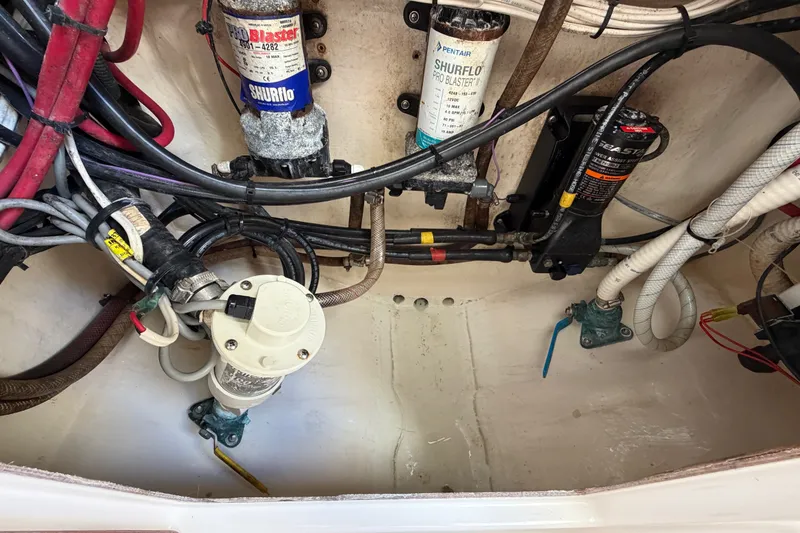 Slide: The Image of Engine compartment of a 2003 Venture 34 Open boat, showing wiring and pumps. - 14
