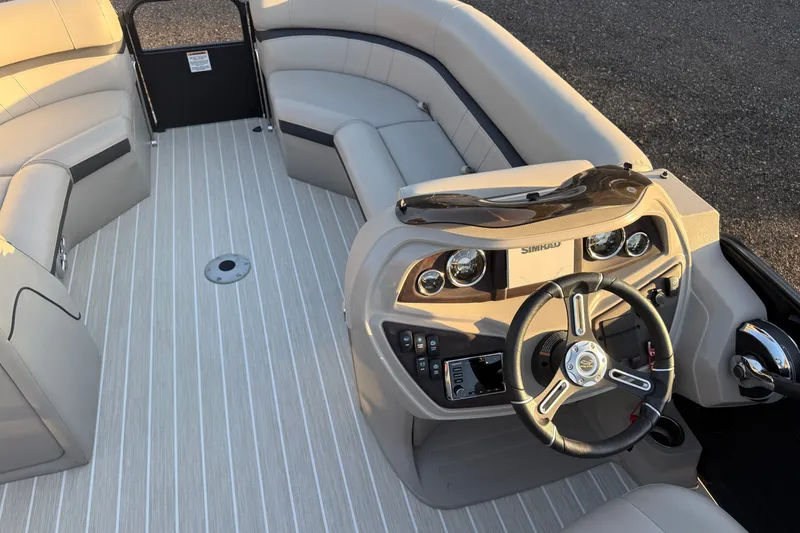 Slide: The Image of Interior of a 2019 South Bay 224E boat with steering wheel and seating. - 15