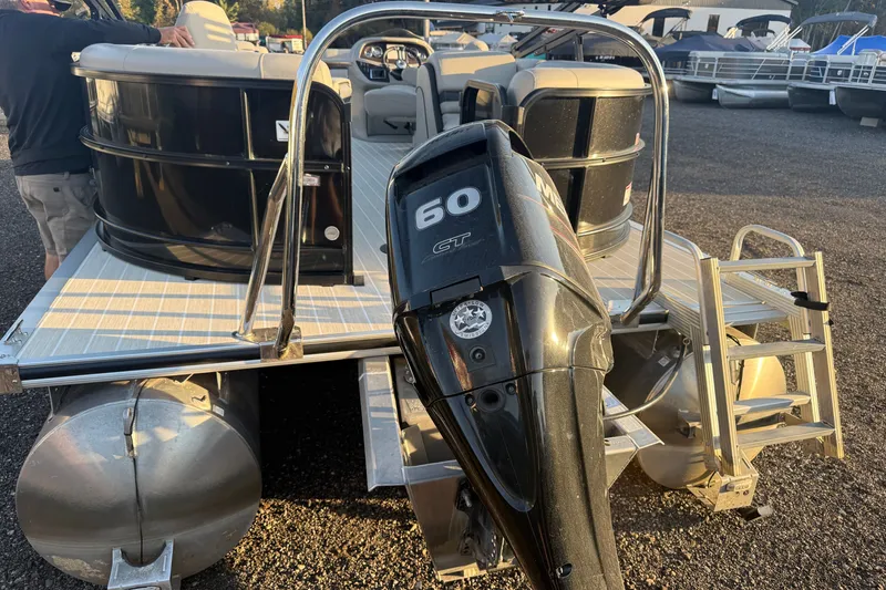 Slide: The Image of 2019 South Bay 224E pontoon boat with 60 HP outboard motor, docked on gravel. - 4